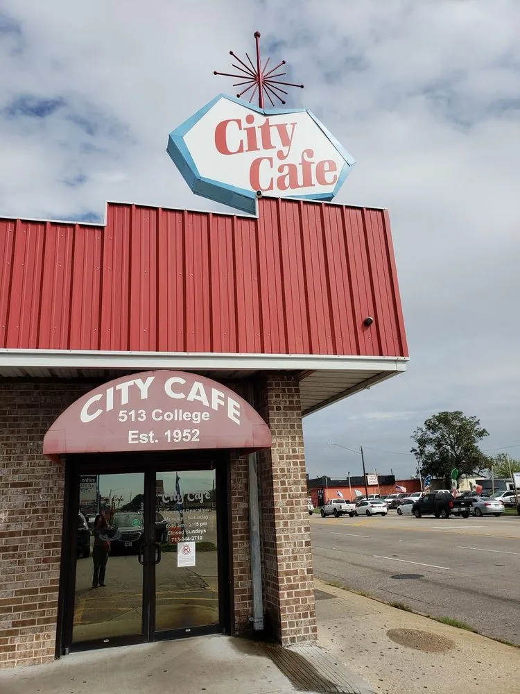 The City Cafe starburst rooftop sign and awning reading 513 College, Est. 1952, in South Houston, Texas